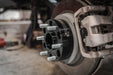 Forged Alloy 2 inch wheel spacer installed on a Chevy Silverado 1500 hub next to the brake caliper