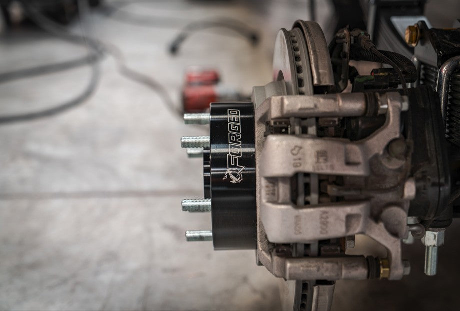 Side profile of installed Forged Alloy 2 inch wheel spacer showing thickness and grade 10.9 studs
